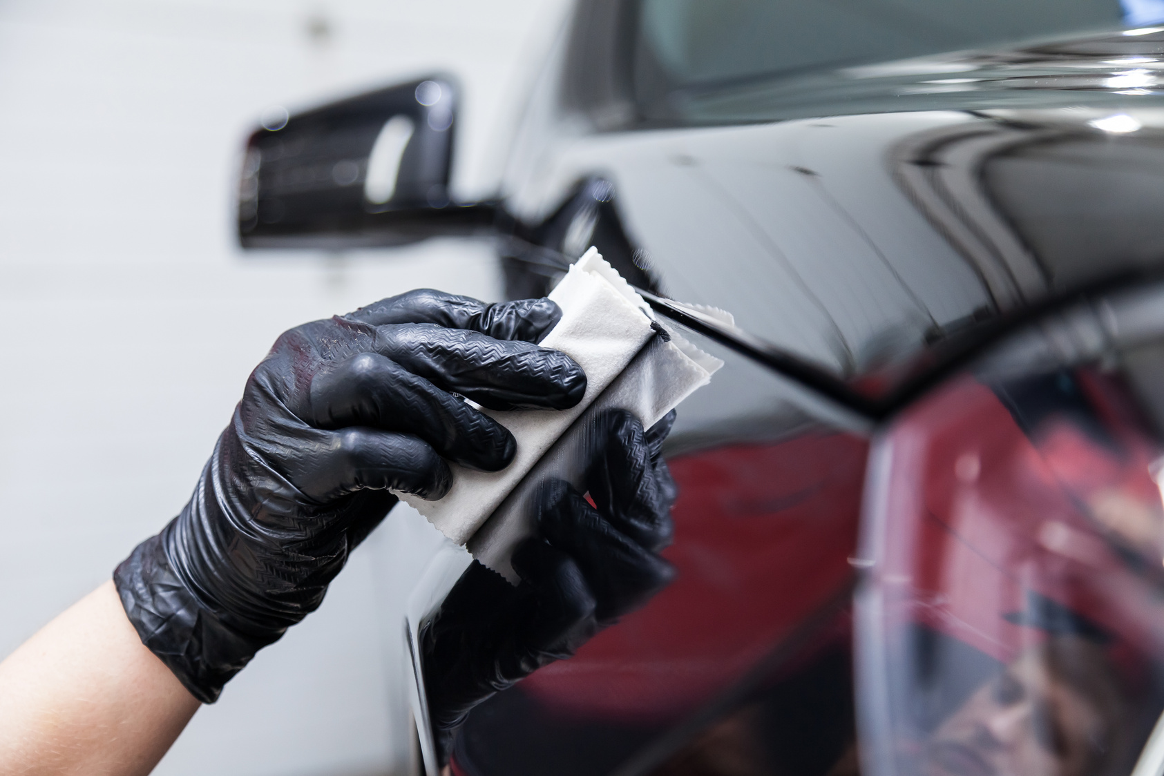 Ceramic coating being applied to vehicle's paint.